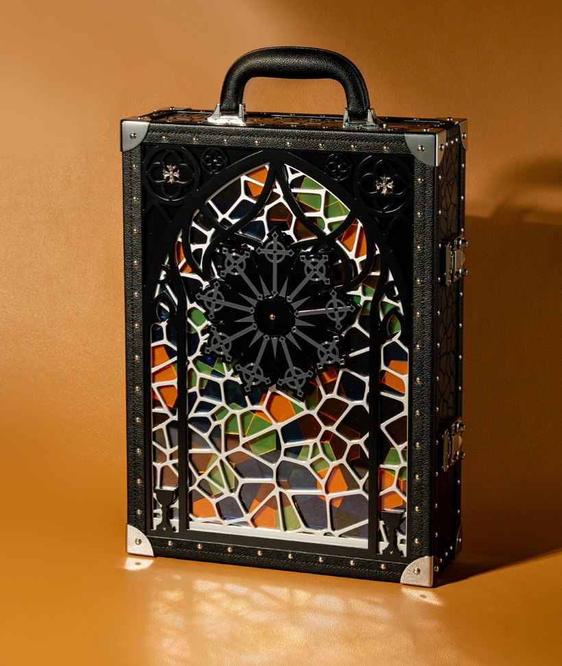 A real trunk case with cut relief over coloured glass, studs and corner caps