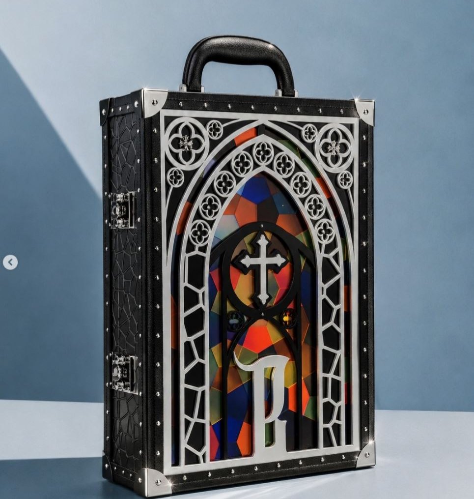 A real trunk case with a cut metal layer over a printed layer and a raised monogram